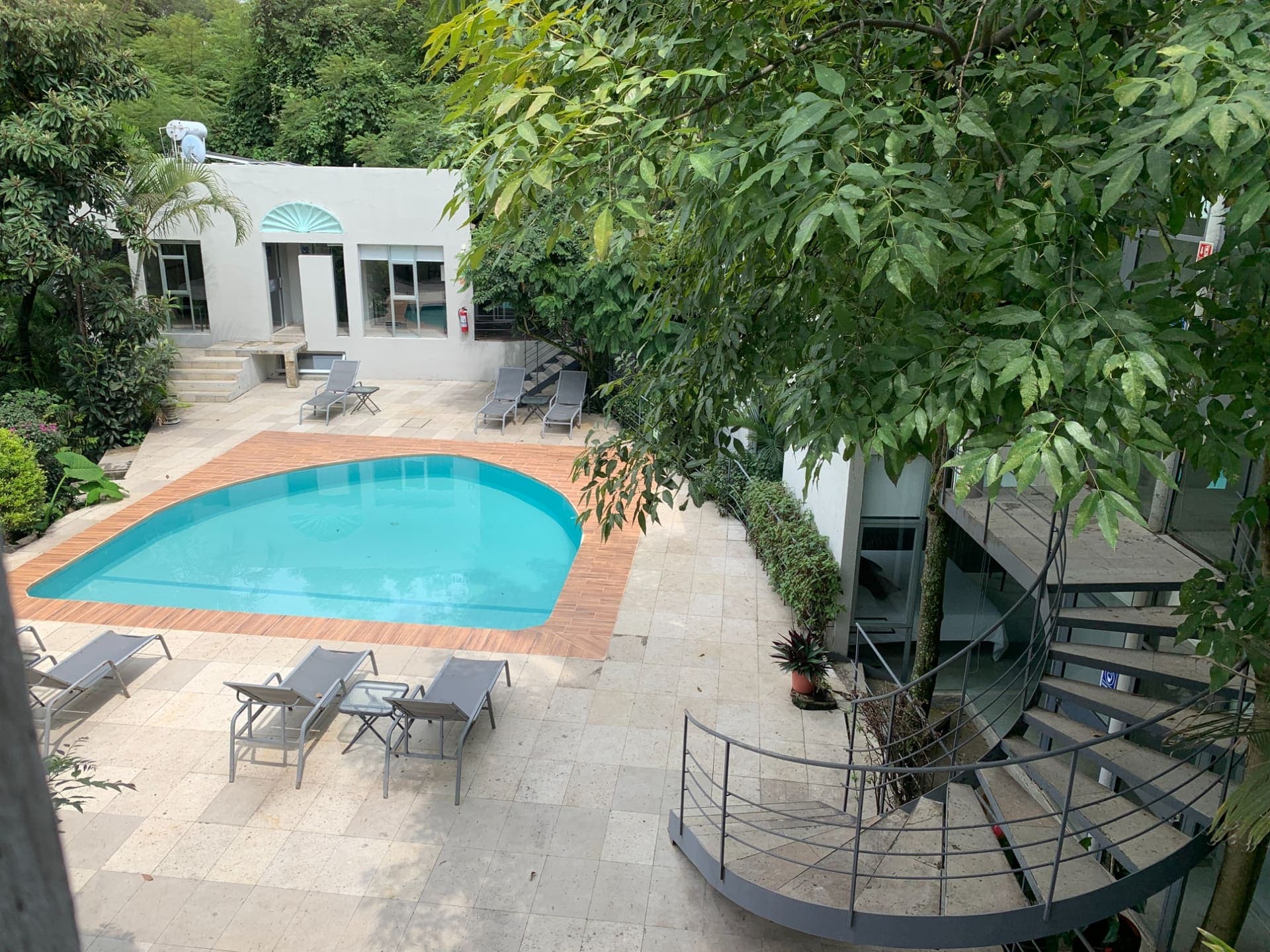 The pool terrace at Casa Tepoztlán seen from above, framed by trees
